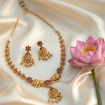 Traditional Antique Matte Gold Plated Temple Jewelry Necklace and Earring Set featuring Goddess Lakshmi and Elephant Motifs adorned with Ruby and Gree